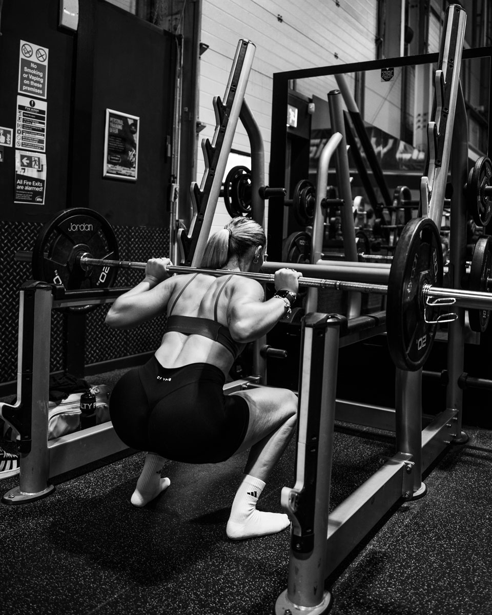 The coach is showing her back muscles.